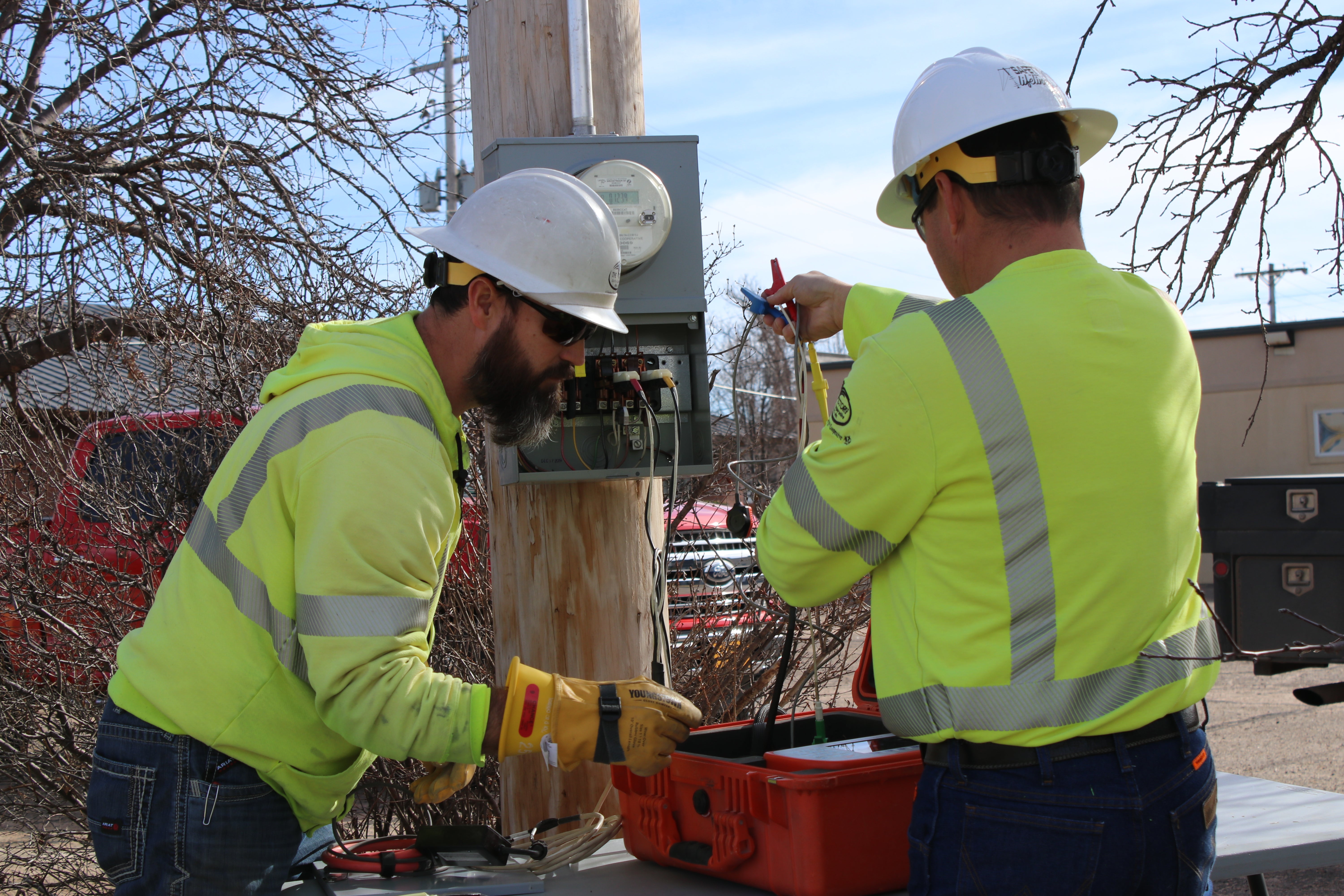 Two metermen working to test a member meter. 