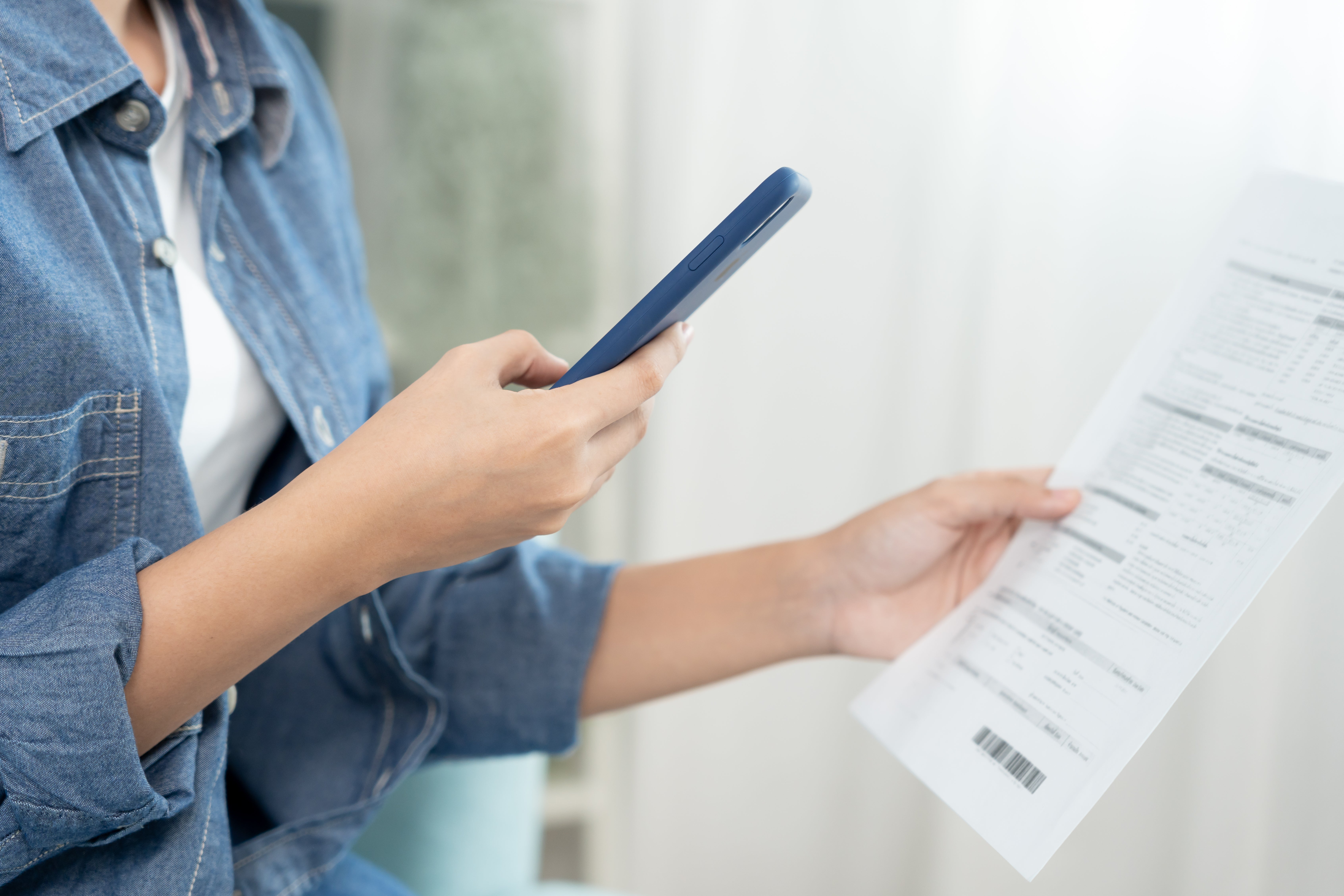 woman paying bill on phone