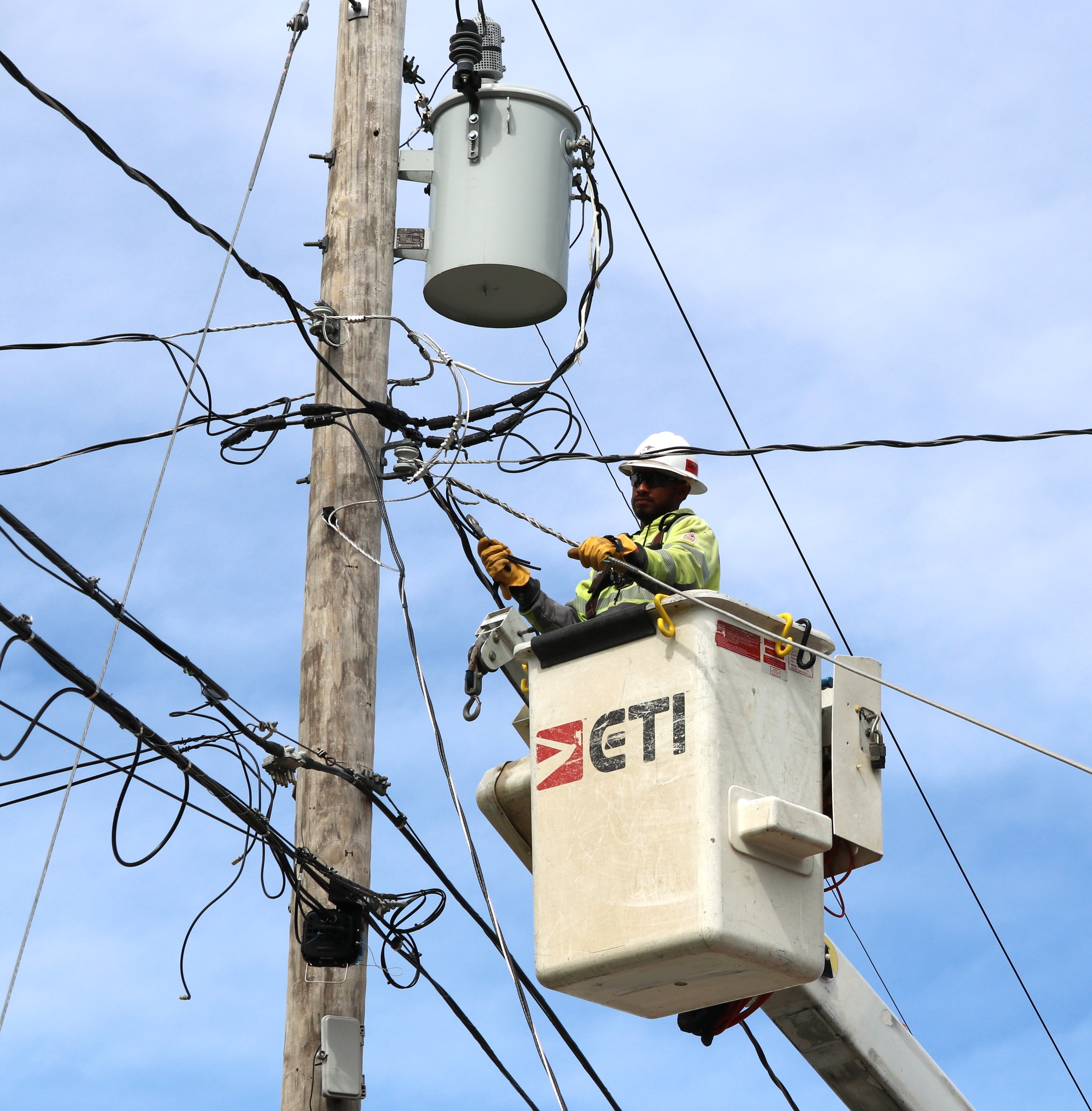 Lineman repairing a line damaged in a storm. 